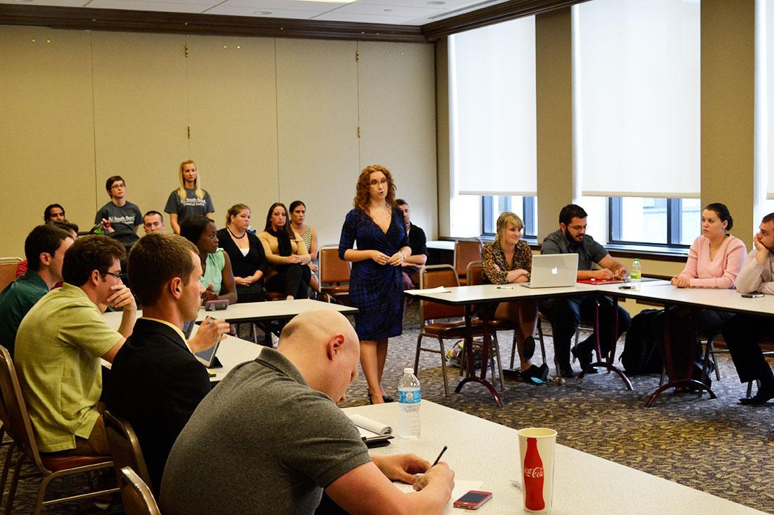 Criminal Justice Club President Christina Smith addresses the SGA with club members and advisers supporting her in the back.