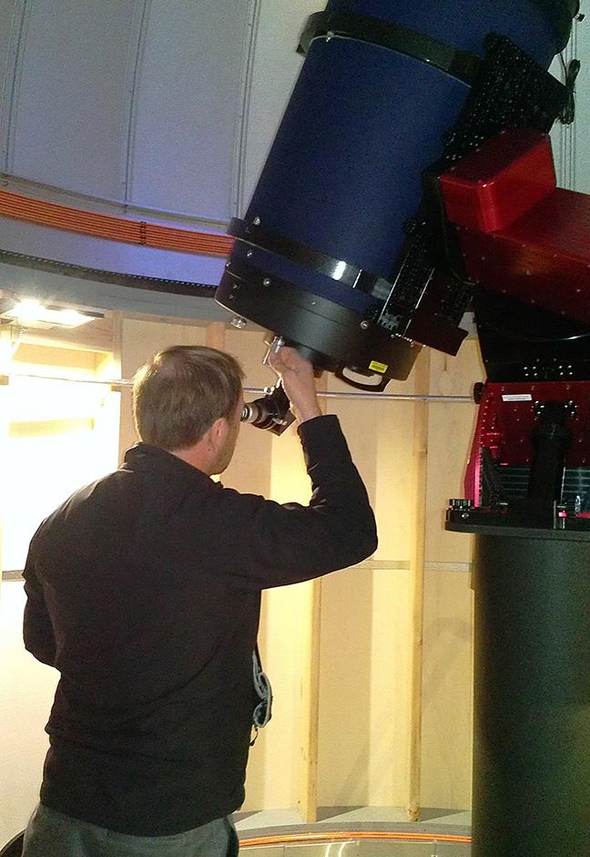 Hinnefeld looks through the telescope.
