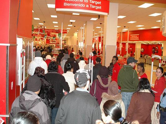 Shoppers flood into Target on Black Friday. Retail stores are opening earlier and earlier on the holiday every year. Some will even stay open on Thanksgiving this year. Photo via/Wikimedia Commons