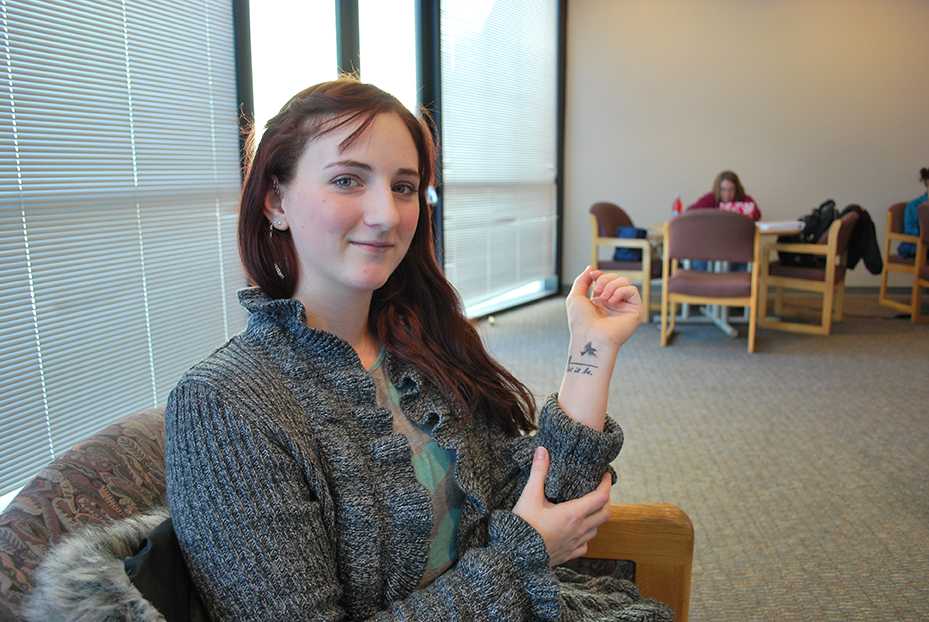 Michell Howell shows off one of her tattoos. For her senior project, she's interviewing tattoo artists in the region. Preface/NICK WORT