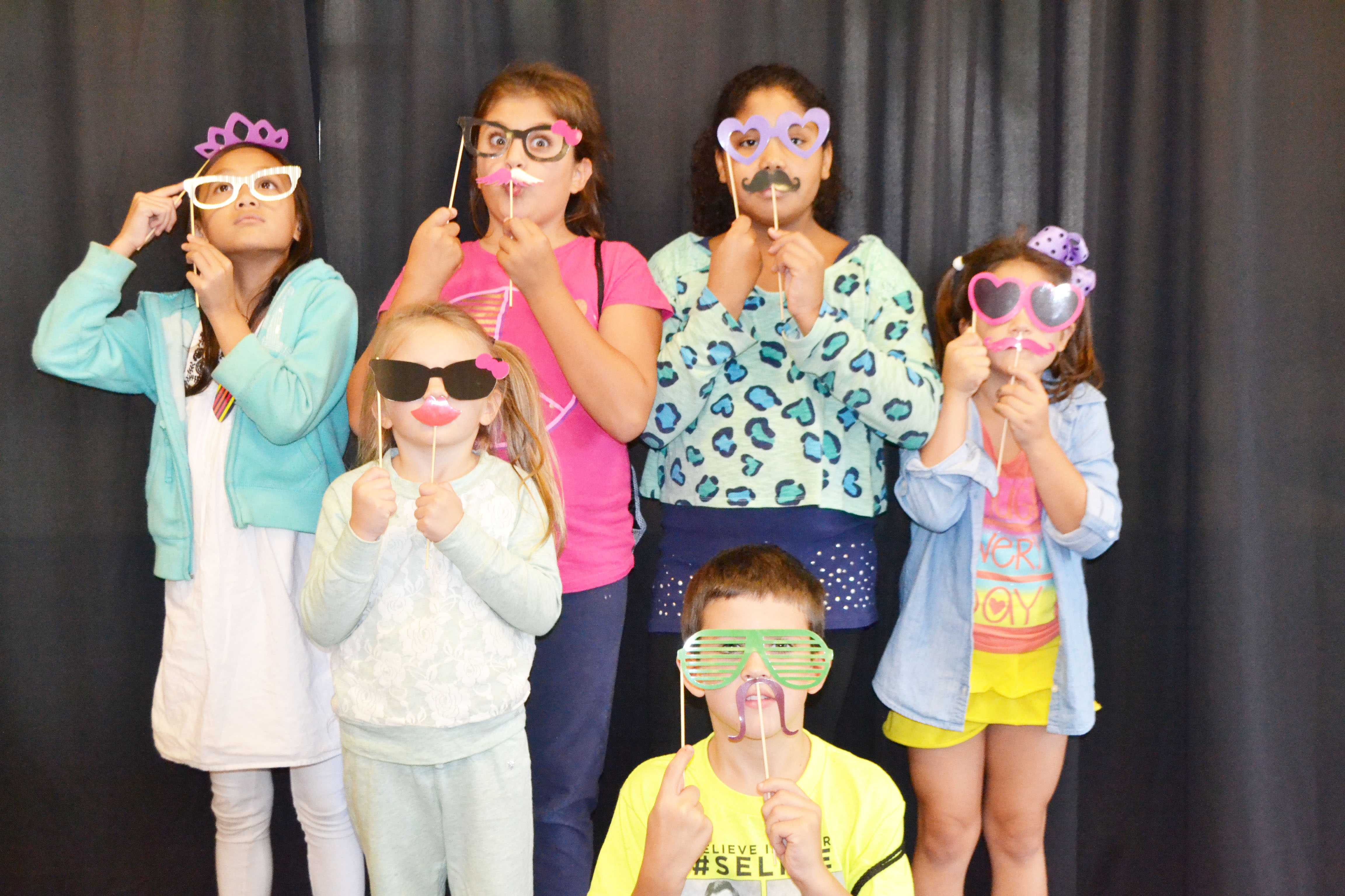 Kids pose in photo booth. Photo credit/Sarah Lynn