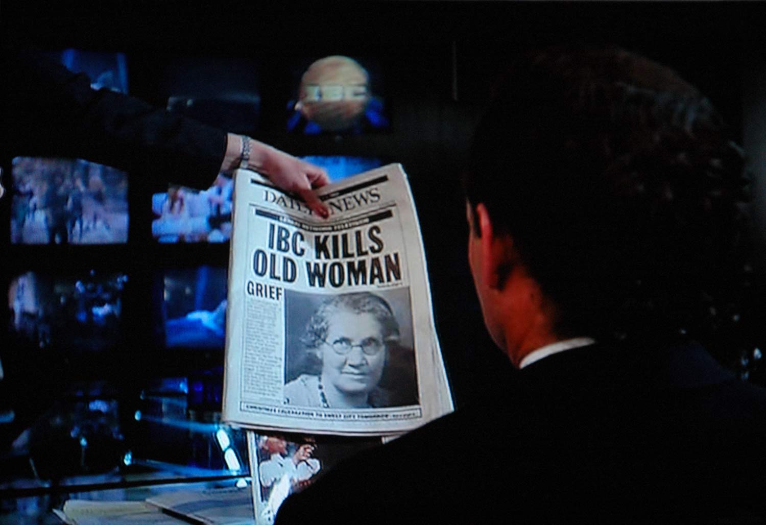 Frank Cross (Bill Murray) reads about the elderly woman who died of a heart attack as a result of his TV promo.