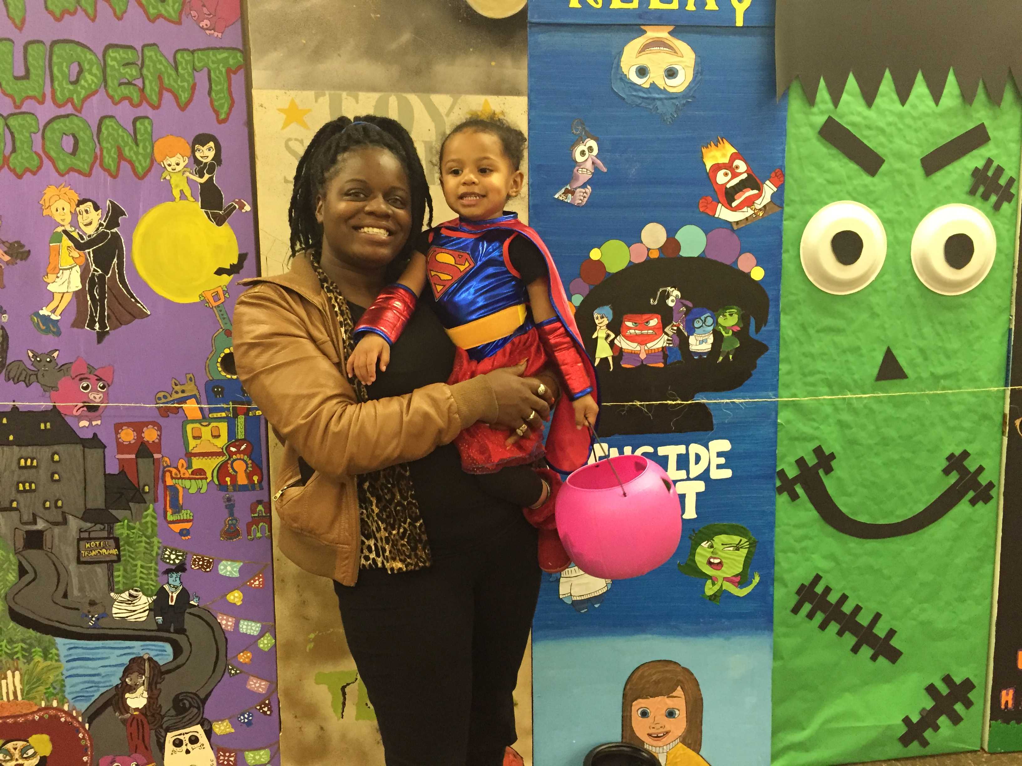 Chanterie McDonald and her daughter in front of the painted doors
