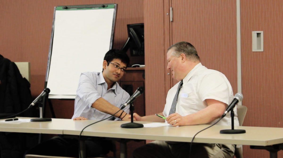 SGA Presidental Candidates Shail Bhagat and Stephen Salisbury shake hands at the SGA debate