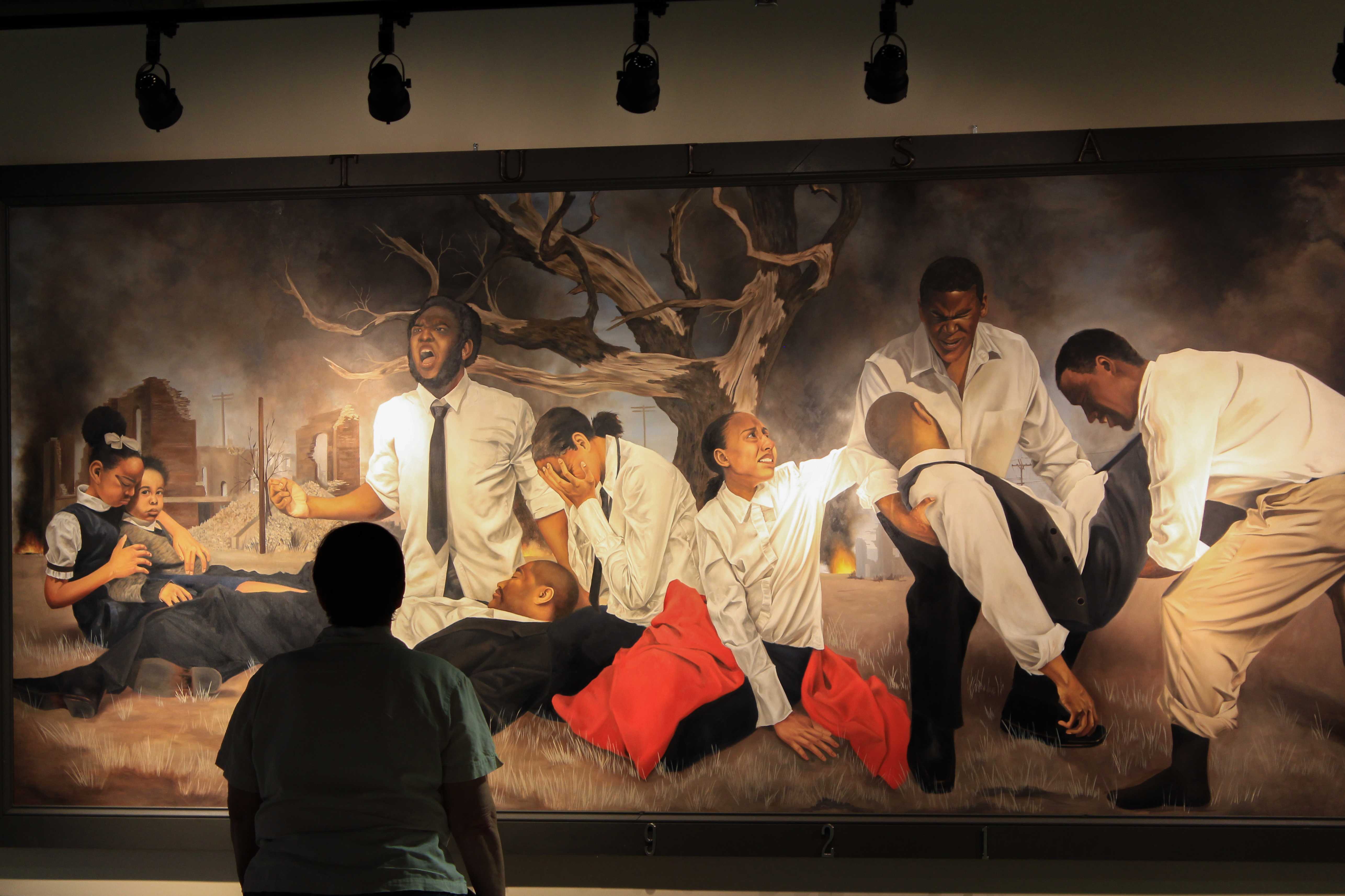 Warren’s painting “In a Promised Land” illustrates the Tulsa Race Riots, a devastating event that occurred in Oklahoma in 1921. PHOTO/BRANDON KRUTSCH
