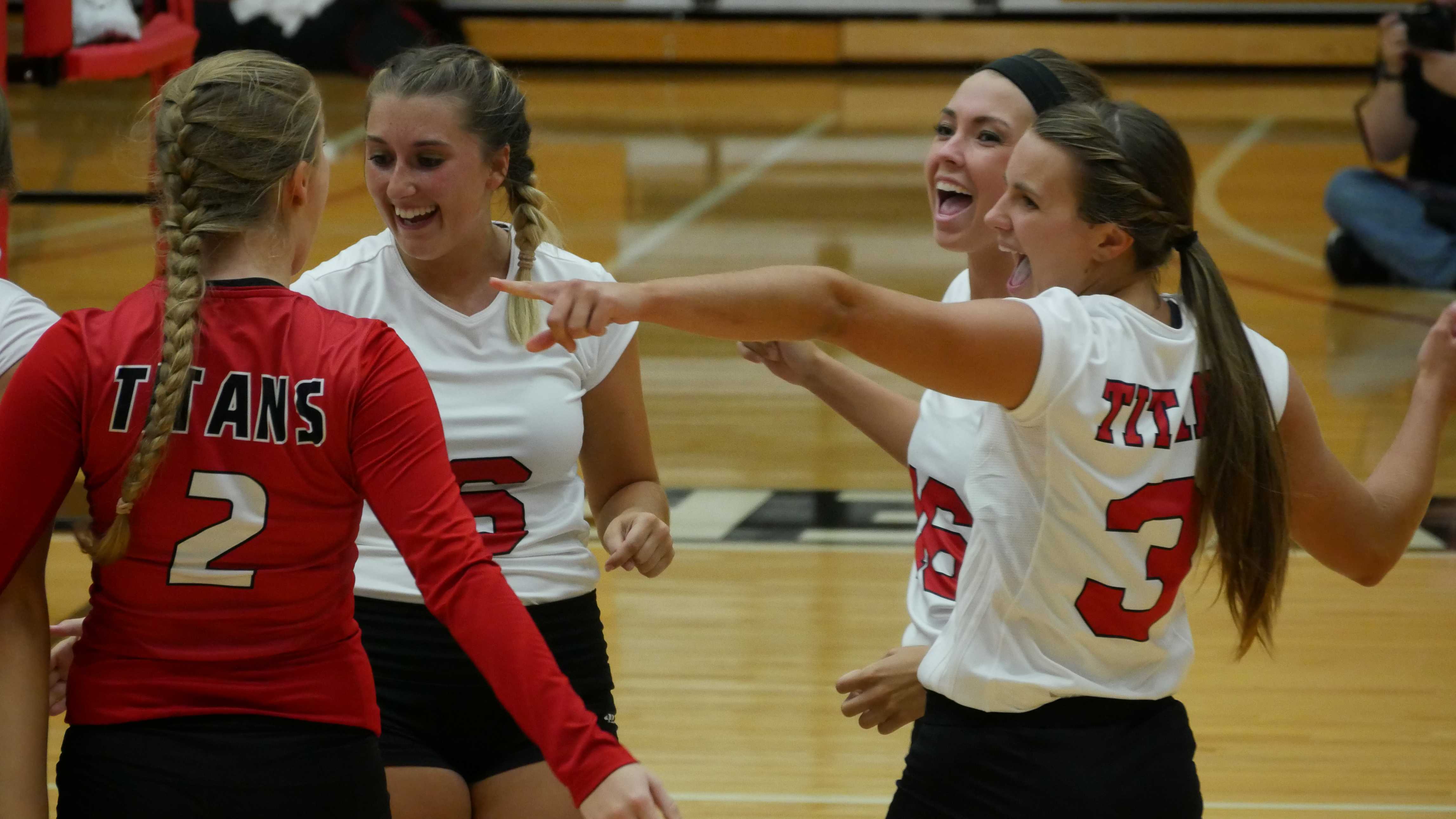 Titan volleyball players celebrate a win. PHOTO/SARAH WHITEHEAD