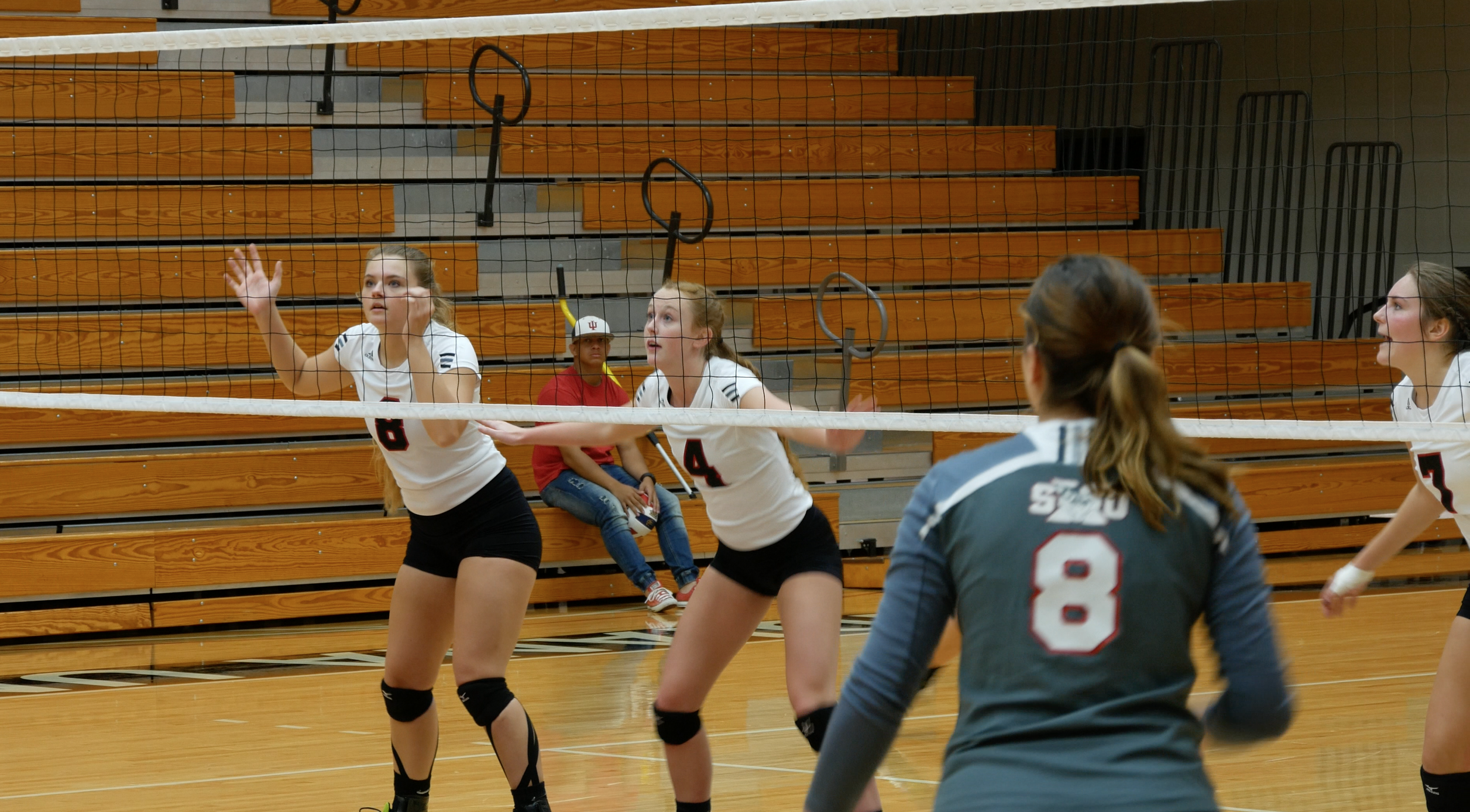 Junior Ashley McClintock (shown middle) prepares for a serve. PHOTO/Sarah Whitehead