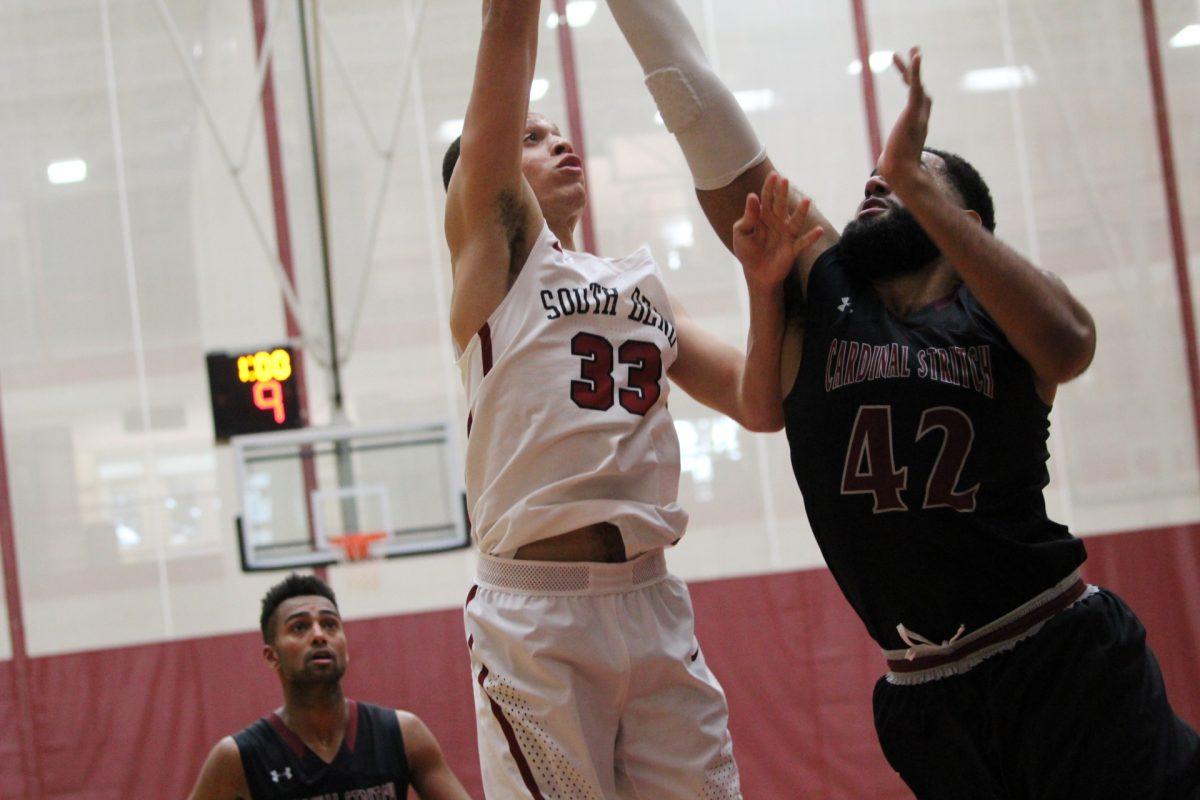 Senior Taylor Brooks fights for the layup against a tough Stritch defense, which notched his second double-double of the season. Photo/Casey McDonald