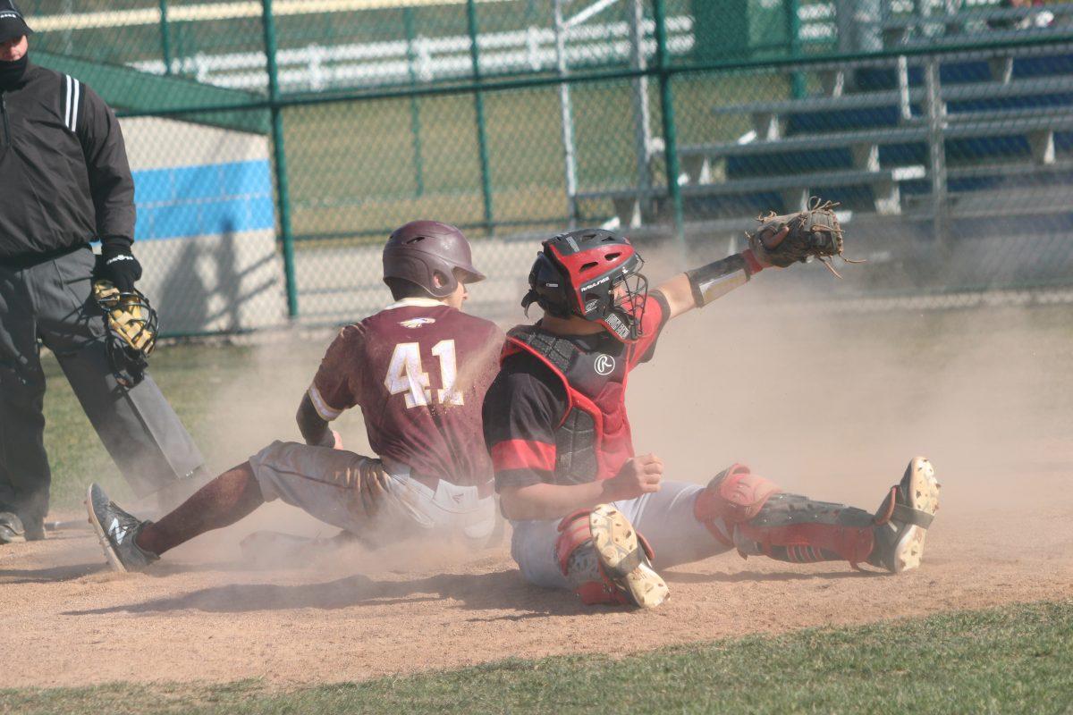 Catcher TJ DeHerrera gets flipped over home plate, yet still able to apply the tag at home, saving a run from scoring after impressive throws from Miller and Thomas.
Photo/Casey McDonald