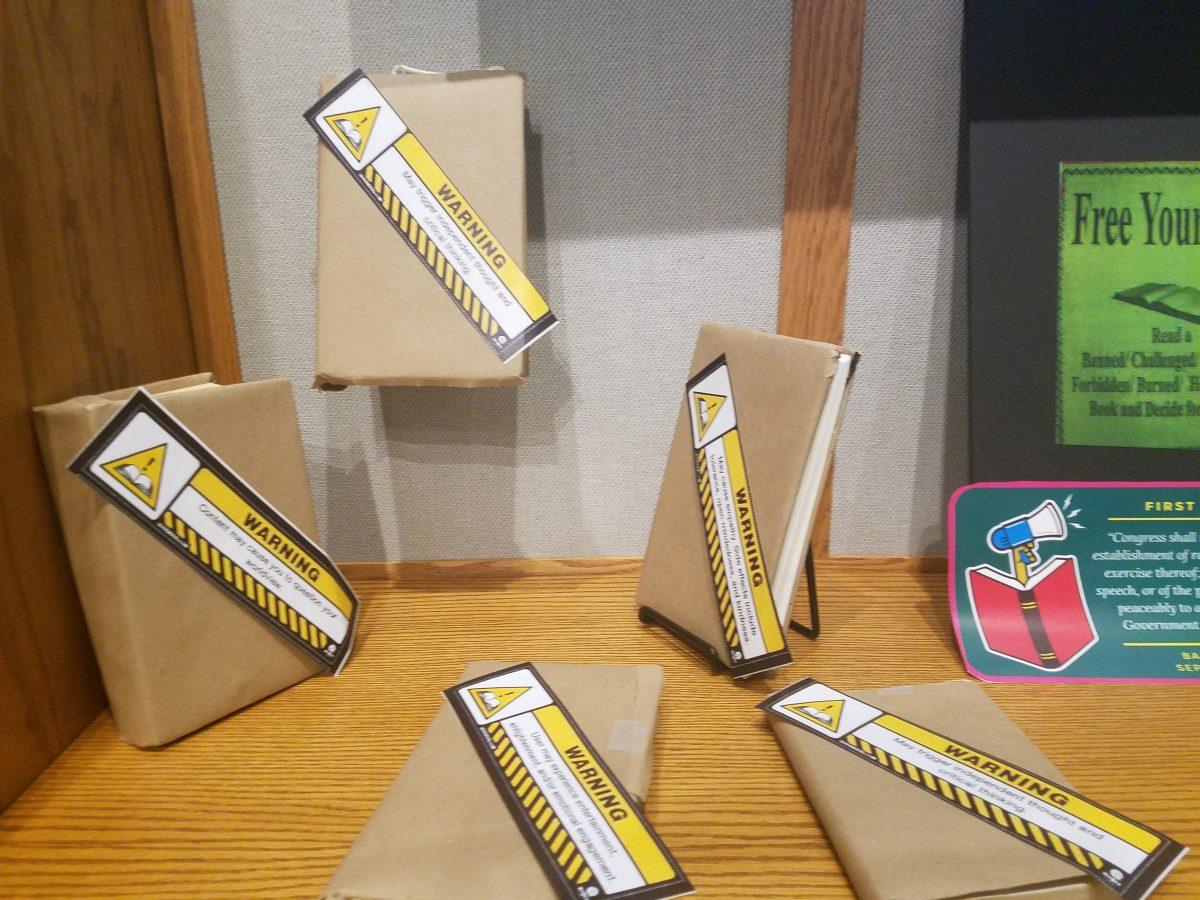 Banned books wrapped up in the display case in the Schurz Library. PHOTO CREDIT/ Eva Monhaut
