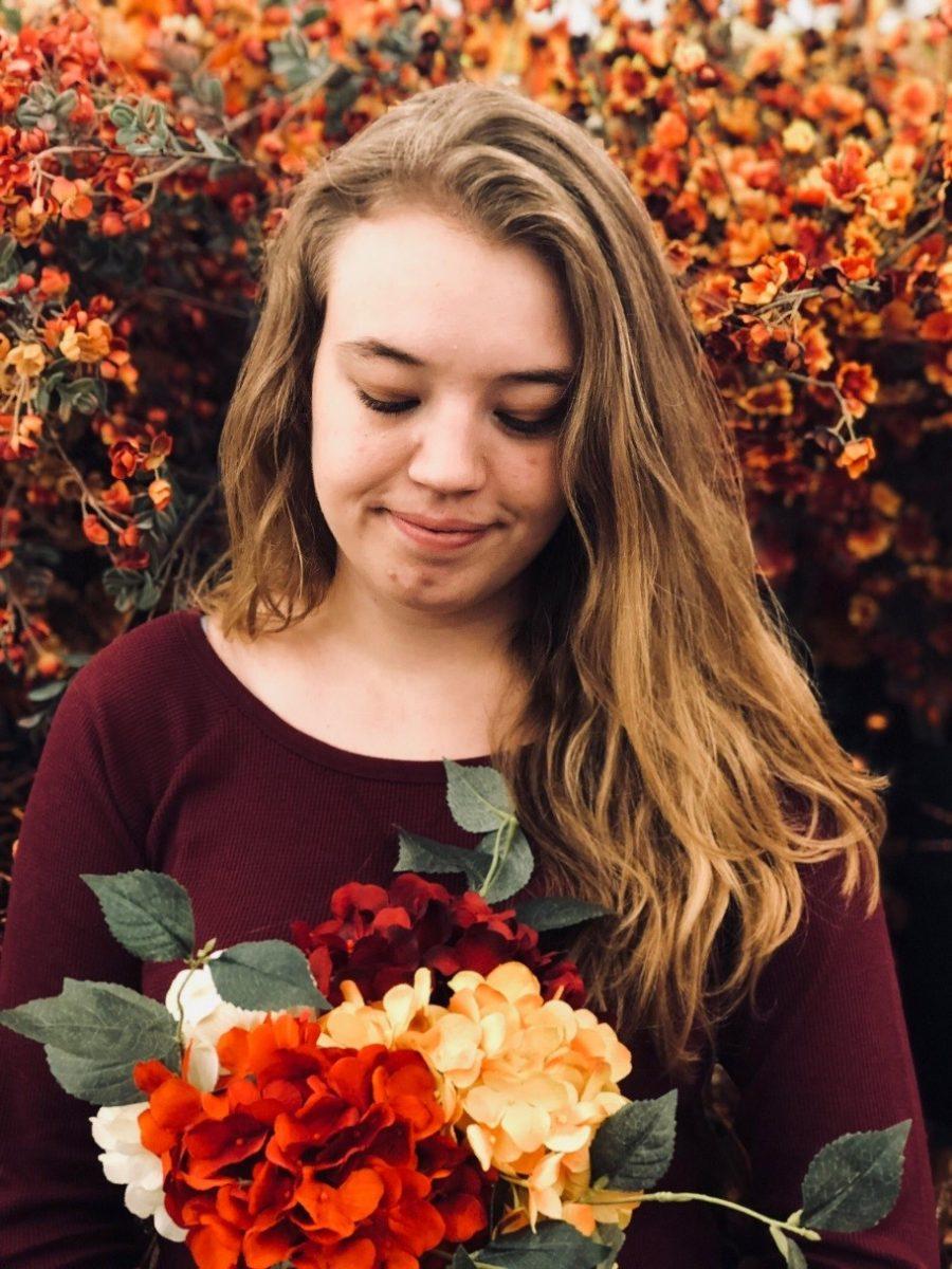 Megan Hayes admires faux flowers in Europe. PHOTO CREDIT/Megan Hayes
