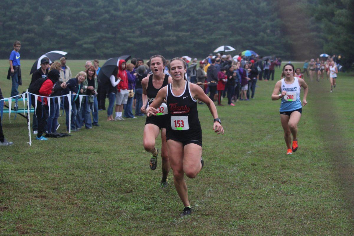 Erin Guzicki, #153, sprints down the finishing chute at the 2018 Bethel College Cross Country Invitational. Photograph provided by Casey McDonald.
