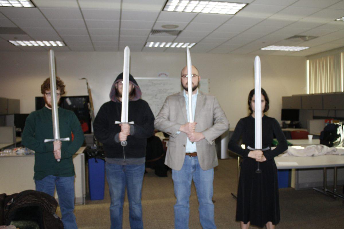 From right to left: Neil Rippey, Blake Herwick, Prof. Richard Ellman, Melanie Garcia.   acting out a LOTR scene during a charades session. Photo provided by Maddie Garcia. 