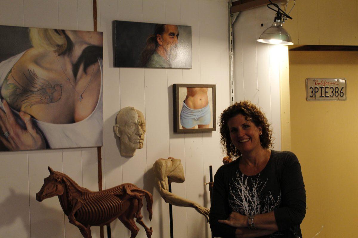 Laura Cutler stands among many of her works throughout the year in her studio in the basement of her gallery. Photo by//KATE LUCE