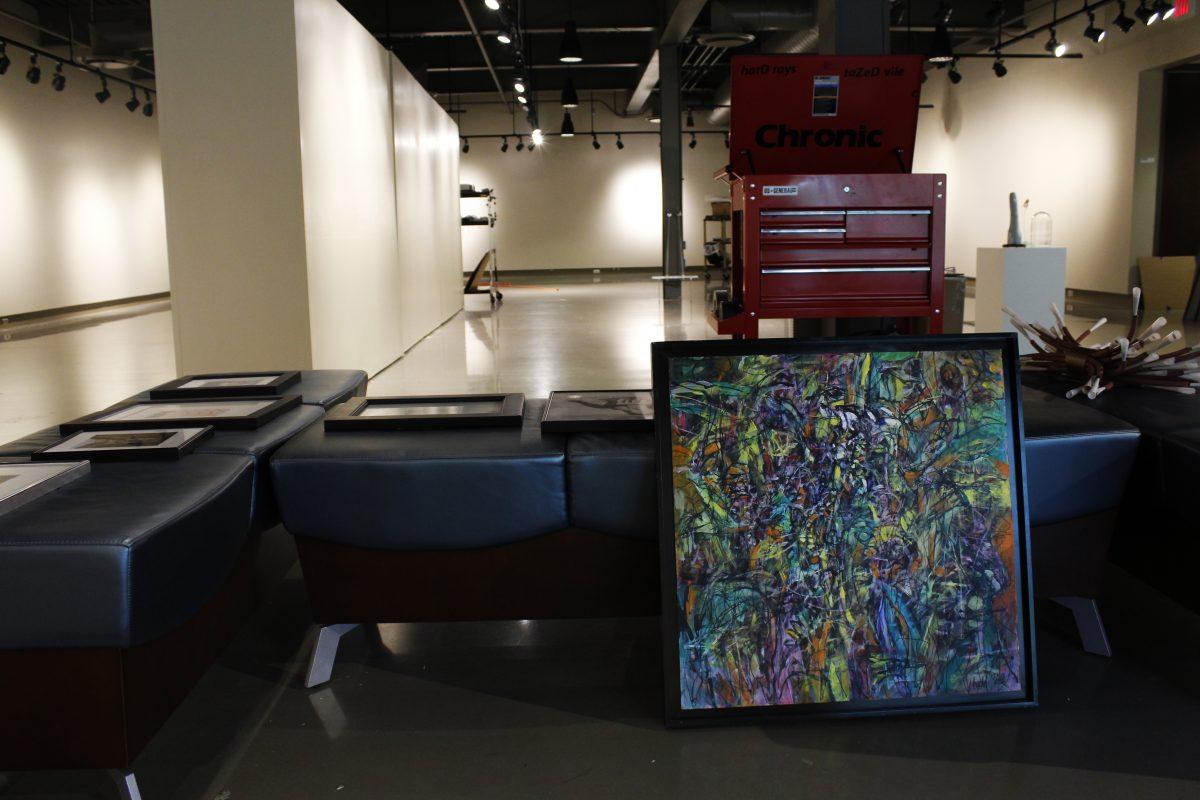 Josh Miller, gallery director, has been framing and hanging work for the upcoming Faculty Exhibition. This exhibition will be open the week of Sept. 23, but opening night and gallery talk are on Oct. 3. Photo by//KATE LUCE