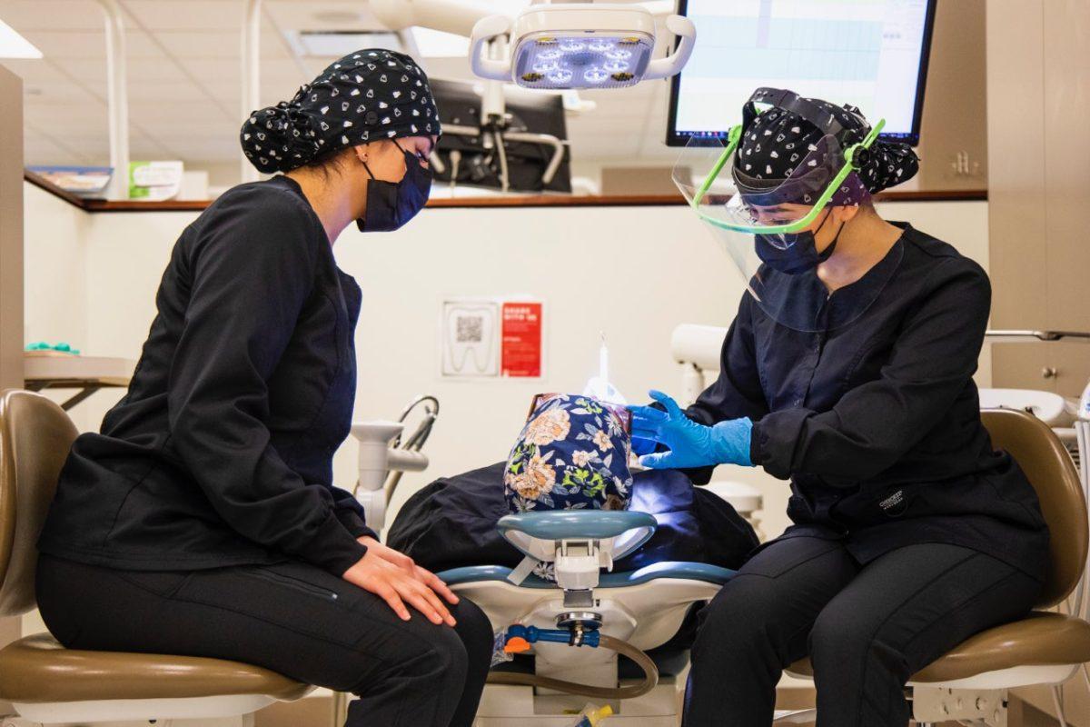 Students and instructors work in a lab setting practicing tooth inspections Tuesday, Sept. 20, 2022 at the IU South Bend Dental Hygiene Clinic on campus in the Education and Arts Building.