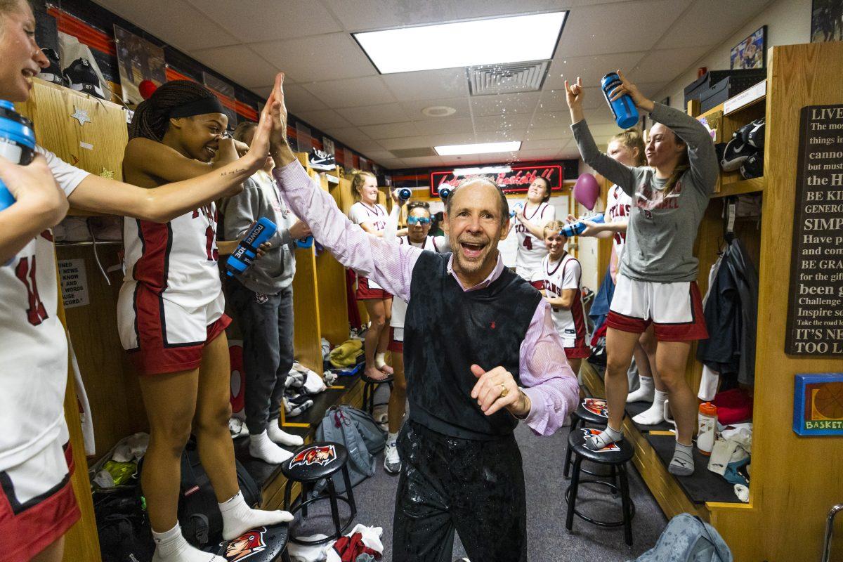 Players douse coach Steve Bruce with water after winning the Indiana University South Bend vs. Indiana University Northwest basketball game Wednesday Feb. 15, 2023 in the Student Activities Center on campus at IUSB. (Photo by Michael Caterina/Indiana University South Bend)